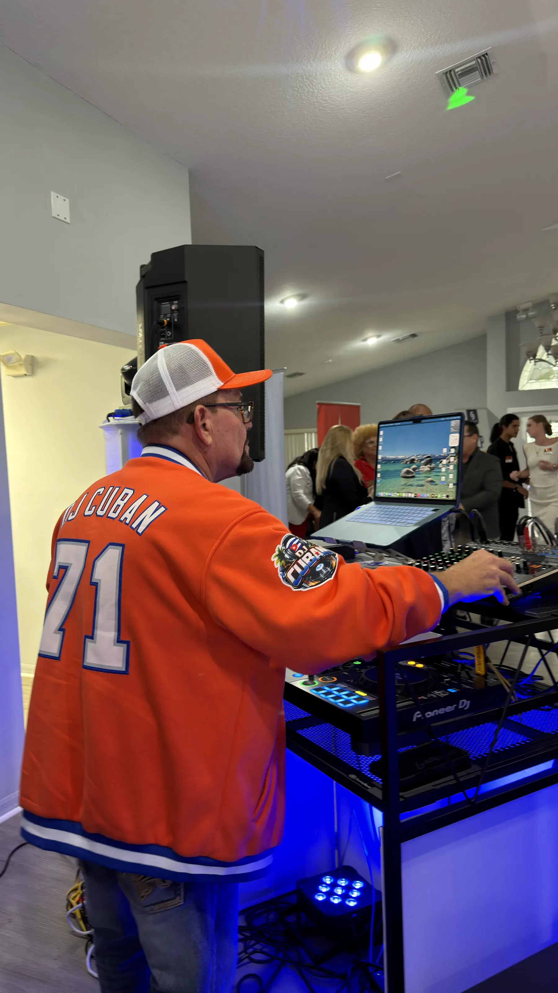 DJ Cuban at the booth in his orange DJ Cuban 71 jersey